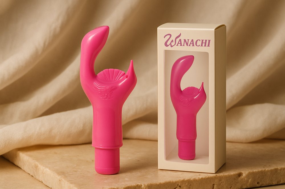 Vibrador Wanachi Multi-Speed rosa con su caja, sobre piedra cálida